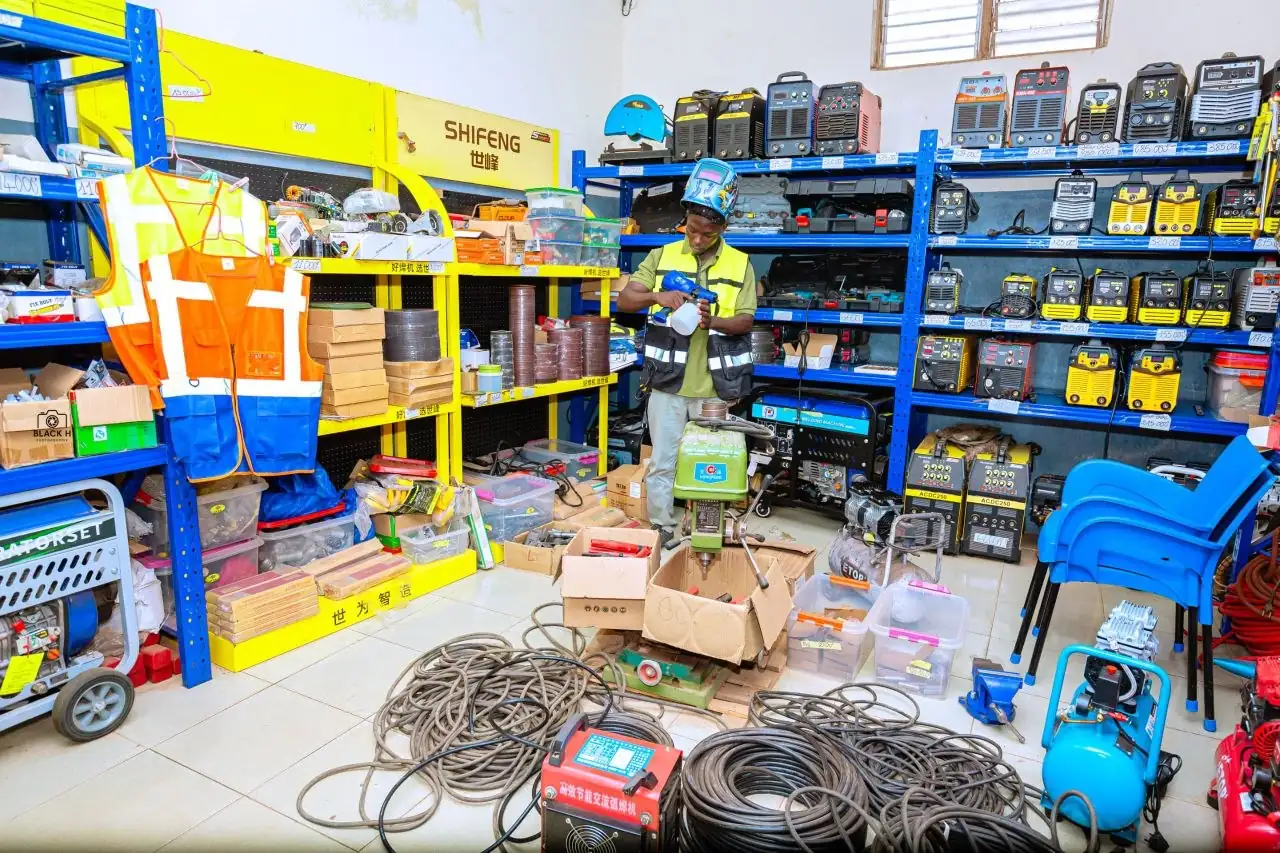 Intérieur de la boutique ECYT à Lomé, rayonnages remplis de postes à souder